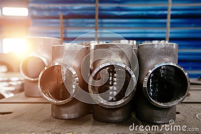 Batch of T shape pipe parts in factory Stock Photo