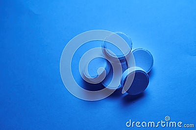 Batch of tablets laying on blue background Stock Photo