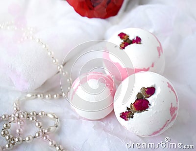 Bath balls, towel, pearl and red rose on white background Stock Photo