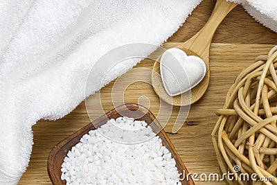 Bath fizzer in heart shape on spoon with beauty products Stock Photo