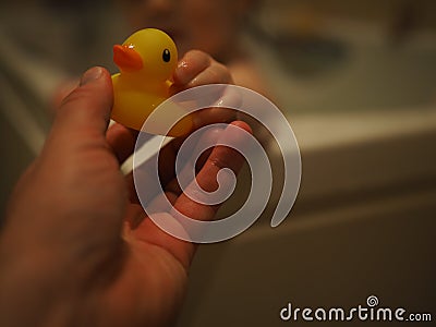 Bath Time with Ducky, Rubber Duck, Child Hand Editorial Stock Photo