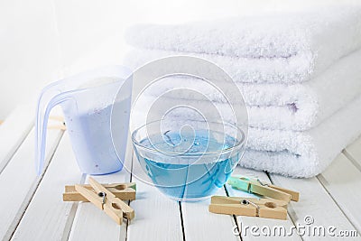 Bath towels, washing powder, fabric softener and wooden clothespins Stock Photo