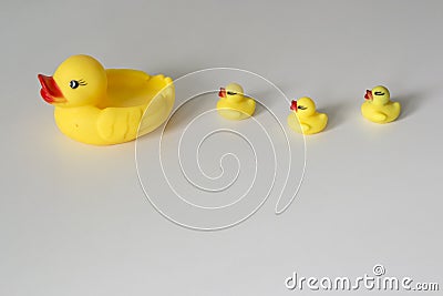 Bath toy row of yellow ducks on white background Stock Photo