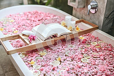 Bath tub with flowers and lemon slices Stock Photo