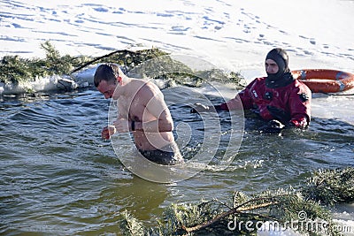 bathing in the hole for baptism, Ukraine, Chernigov. Editorial Stock Photo