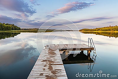 Bathing jetty at the lake Schaalsee during sunrise in Seedorf, Germany Stock Photo