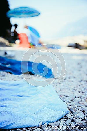 Bathing towel on the beach, other people in blurry background Stock Photo