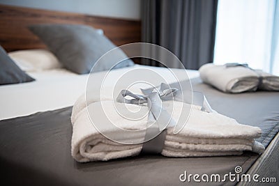 Bathrobe on bed in hotel room Stock Photo