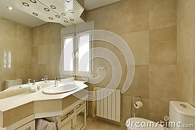 Bathroom with cream marble sink, large frameless wall mirror Stock Photo