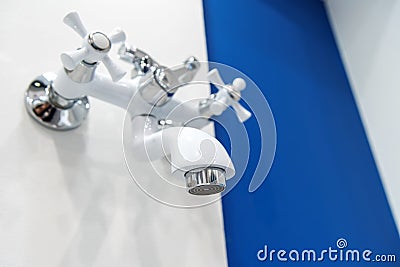 Bathroom faucet. White tap with chrome elements on the wall in the bathroom Stock Photo