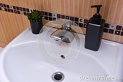 Bathroom interior with sink and faucet in an ordinary house Stock Photo