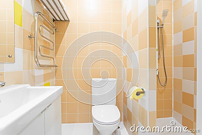Bathroom with shower, toilet bowl and sink. Hotel standart bedroom. simple and stylish interior. interior lighting Stock Photo