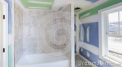 Bathroom remodel progresses as drywall is smoothed, covering seams and screws with tape Stock Photo