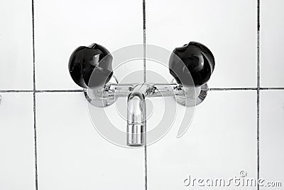 Bathroom sink and faucet with black mixing knobs . Close up shot, no people Stock Photo