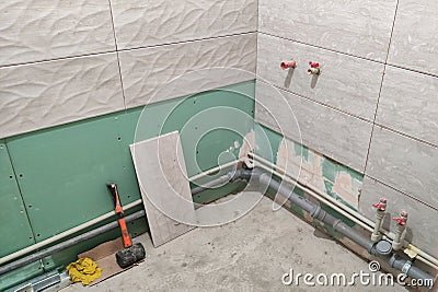 Bathroom tile installation, construction work in the corner of the room Stock Photo