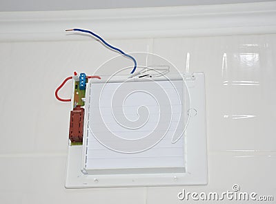 Bathroom ventilation fan, exhaust fan installation on a tiled wall. Wiring a bathroom ventilation fan Stock Photo