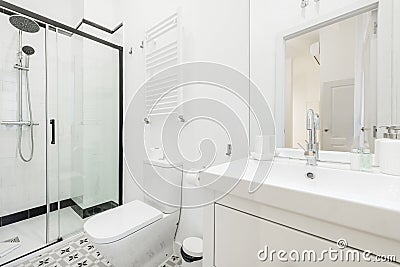 Bathroom with white porcelain sink, frameless mirror, chrome fixtures, Stock Photo