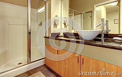 Bathroom with wood modern cabinets and white sink. Stock Photo