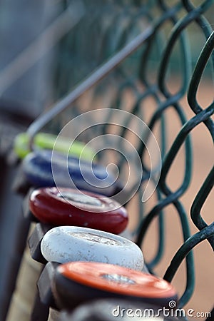 Baseball bat softball bats hanging on a fence Stock Photo