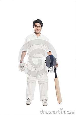 Batsman holding a cricket bat with sports helmet and smiling Stock Photo