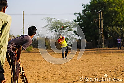 A batsman playing game of cricket,best man beautiful of four run shot,young boy playing cricket in rural area in evening time, Editorial Stock Photo