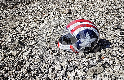 Battered motorcycle helmet on the beach Editorial Stock Photo