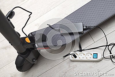 Battery charging process of electric motorized scooter Stock Photo