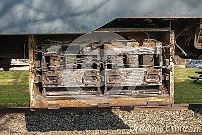 Battery compartment with removable batteries attached to the undercarriage of an antique railroad train car. Stock Photo