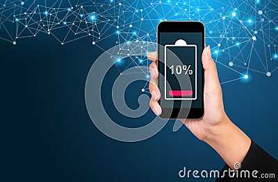 Battery low concept. Battery low on smartphone screen in businesswoman hand Stock Photo