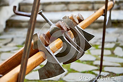 Battle axes of ancient warriors on a stand. The battle axe is an effective melee weapon of medieval warriors . Stock Photo