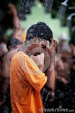 Close-up of young boy devotee having shower ritual in Thaipusam Festival. Editorial Stock Photo