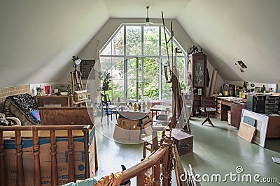 Interior of a artist`s studio with large light window Editorial Stock Photo