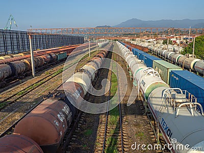 Railroad in the city against the backdrop of mountains.. Many railway paths. Wagons and trains on the tracks. Tank wagons Editorial Stock Photo