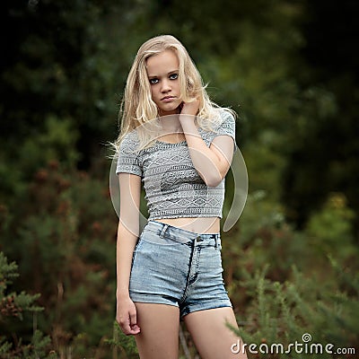 Bautiful Blond Teenage Girl Alone In The Woods Stock Photo