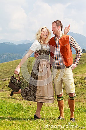 Bavarian couple in fashionable leather pants and dirndl Stock Photo