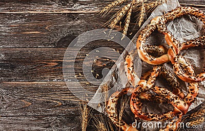 Bavarian pretzels with with sunflower seeds, brown wooden background Stock Photo