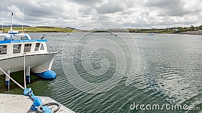 Bay on Inishbofin Island with boats and a ship docked in the harbor Stock Photo