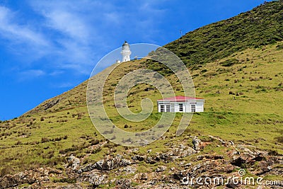 Bay of Islands, New Zealand: Lighthouse and hut on Cape Brett Stock Photo
