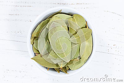 Bay leaf leaves spice herb from above bowl wooden board Stock Photo