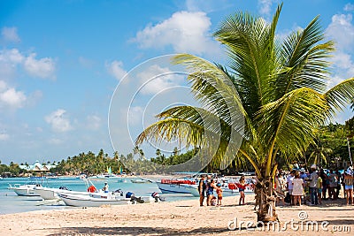BAYAHIBE, DOMINICAN REPUBLIC - MAY 21, 2017: Tourists near boats. caribbean landscape. Copy space for text. Editorial Stock Photo