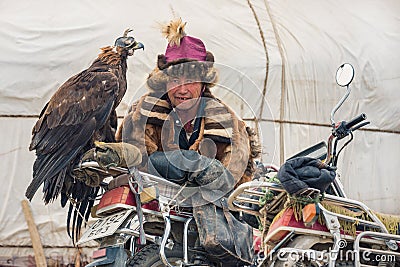 BAYAN-OLGII PROVINCE, MONGOLIA - OCT. 01, 2017: Traditional Mongolian Golden Eagle Festival. Unknown Mongolians Hunter Berkutch Editorial Stock Photo