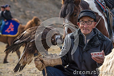 BAYAN-OLGII PROVINCE, MONGOLIA - OCT. 01, 2017: Traditional Mongolian Golden Eagle Festival. Unknown Old Mongolians Hunter Berk Editorial Stock Photo