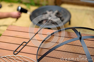 Bbq grill charcoal starting fire with hair dryer in backyard in england uk Stock Photo
