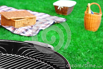 BBQ Grill,Picnic Basket With Wine, Blanket On The Lawn Stock Photo