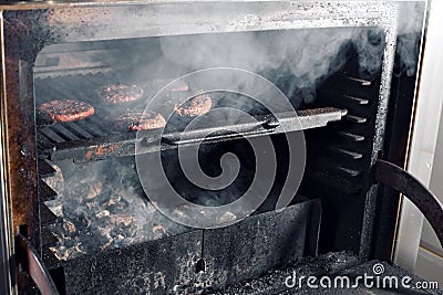 BBQ Grilled Burgers Patties On The Hot Flaming Charcoal Grill, Food, Good Snack For Outdoor Party Or Picnic Stock Photo