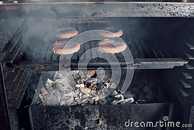BBQ Grilled Burgers Patties On The Hot Flaming Charcoal Grill, Food, Good Snack For Outdoor Party Or Picnic Stock Photo