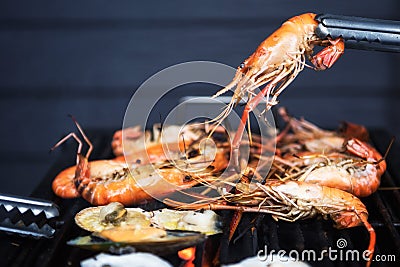 BBQ Grilled shrimps on flaming grill Stock Photo