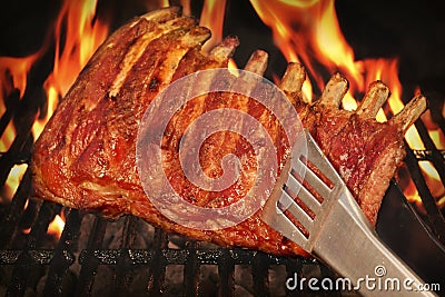 BBQ Roasted Baby Back Pork Ribs On Hot Flaming Grill Stock Photo