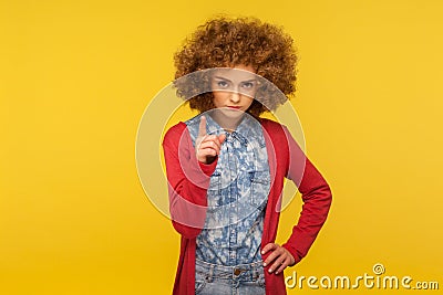 Be careful! Portrait of serious woman with curly hair in casual outfit looking displeased and giving advice Stock Photo