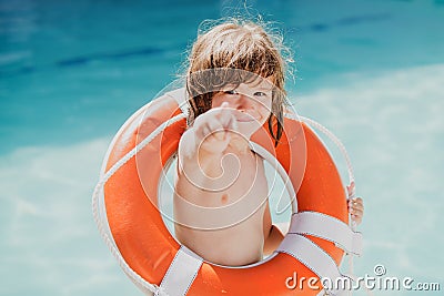 Be careful on water. Kids saving life. Helping concept. Child with rescue circle. Summer beach. Stock Photo